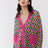 Model wears longline Magda longline cardigan in pink and multicolour origami pattern
